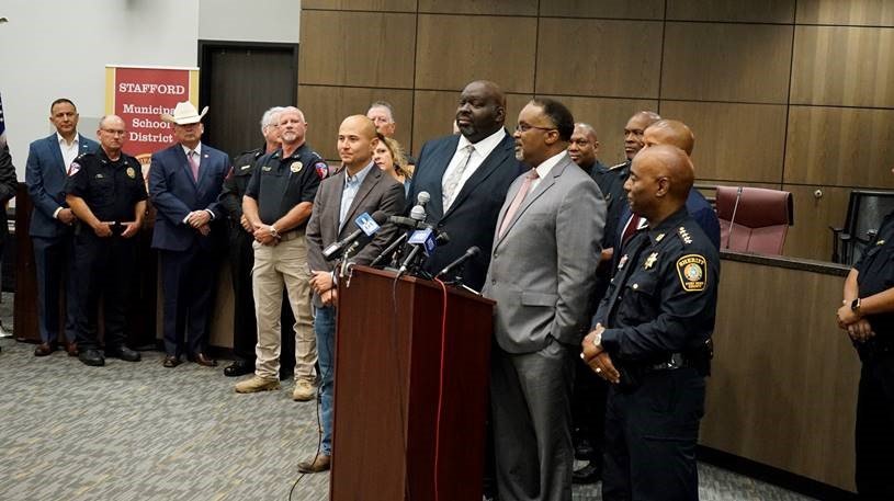 Fort Bend County Sheriff Eric Fagan, in the foreground, joined school officials from Fort Bend County school districts to discuss safety measures before school resumes for many area students this month. Katy Police Chief Noe Diaz is third from left, wearing his hat.